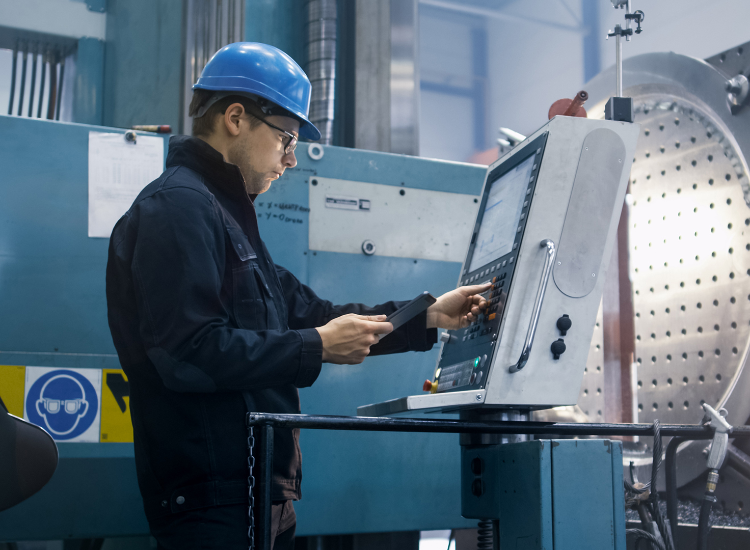 Homme utilisant un terminal dans une chaîne de production